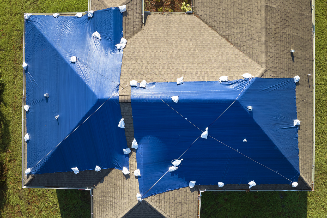 Emergency board-up and tarping crew securing property
