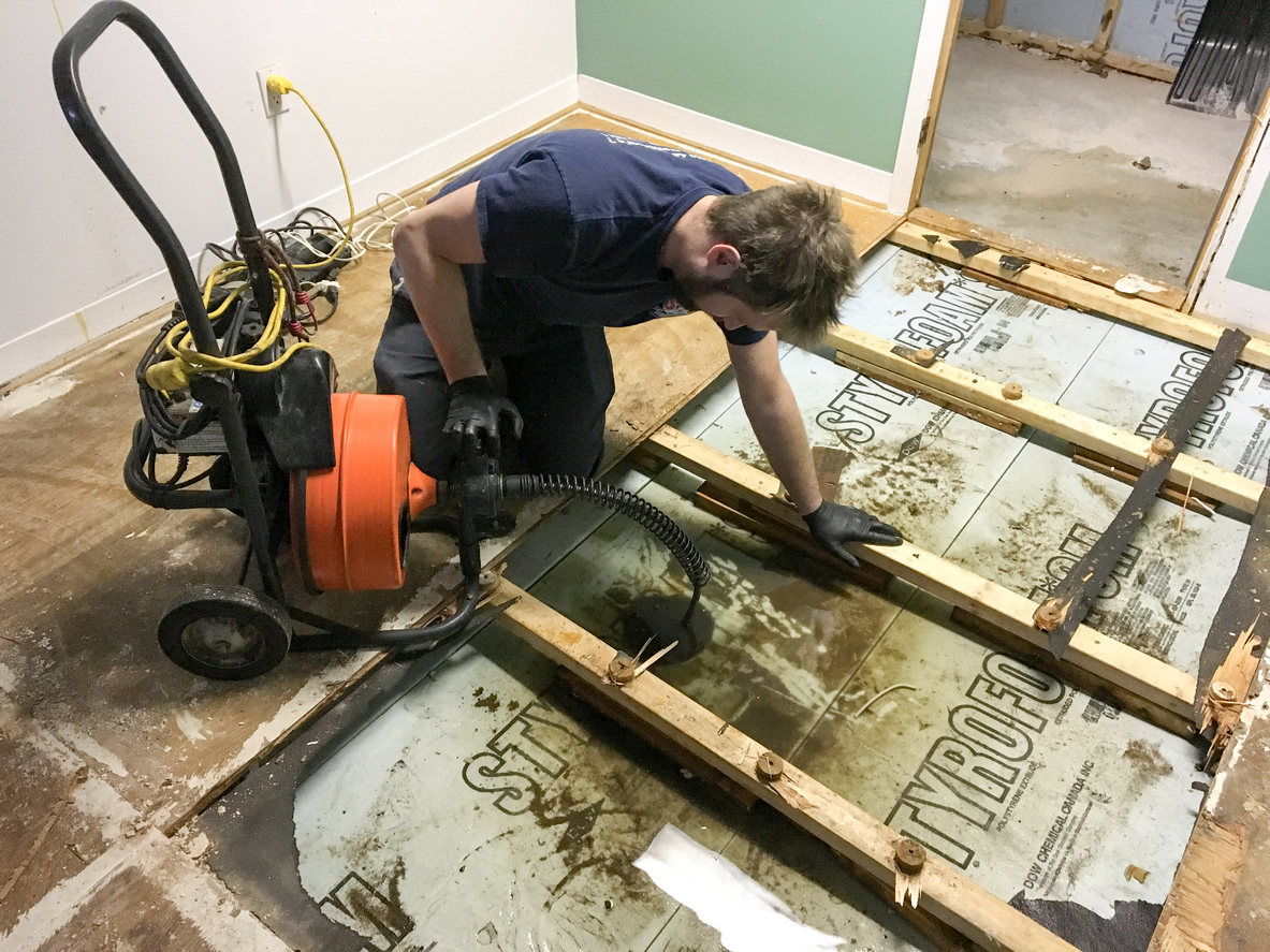 Professional sewage cleanup crew in protective equipment